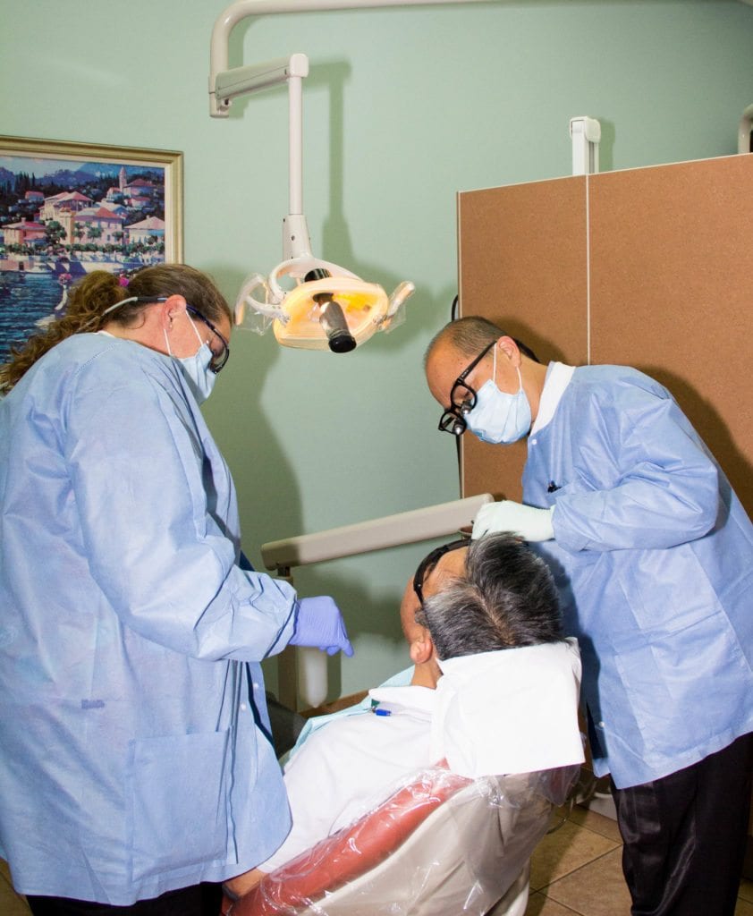 Dr. Ma provides restorative dentistry services to a patient at the Palm Beach Gardens Everlasting Smiles dental office. 